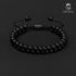 Mattschwarzes Onyx-Armband von Uniqal, luxuriös präsentiert auf schwarzem Hintergrund, zweireihiges Design